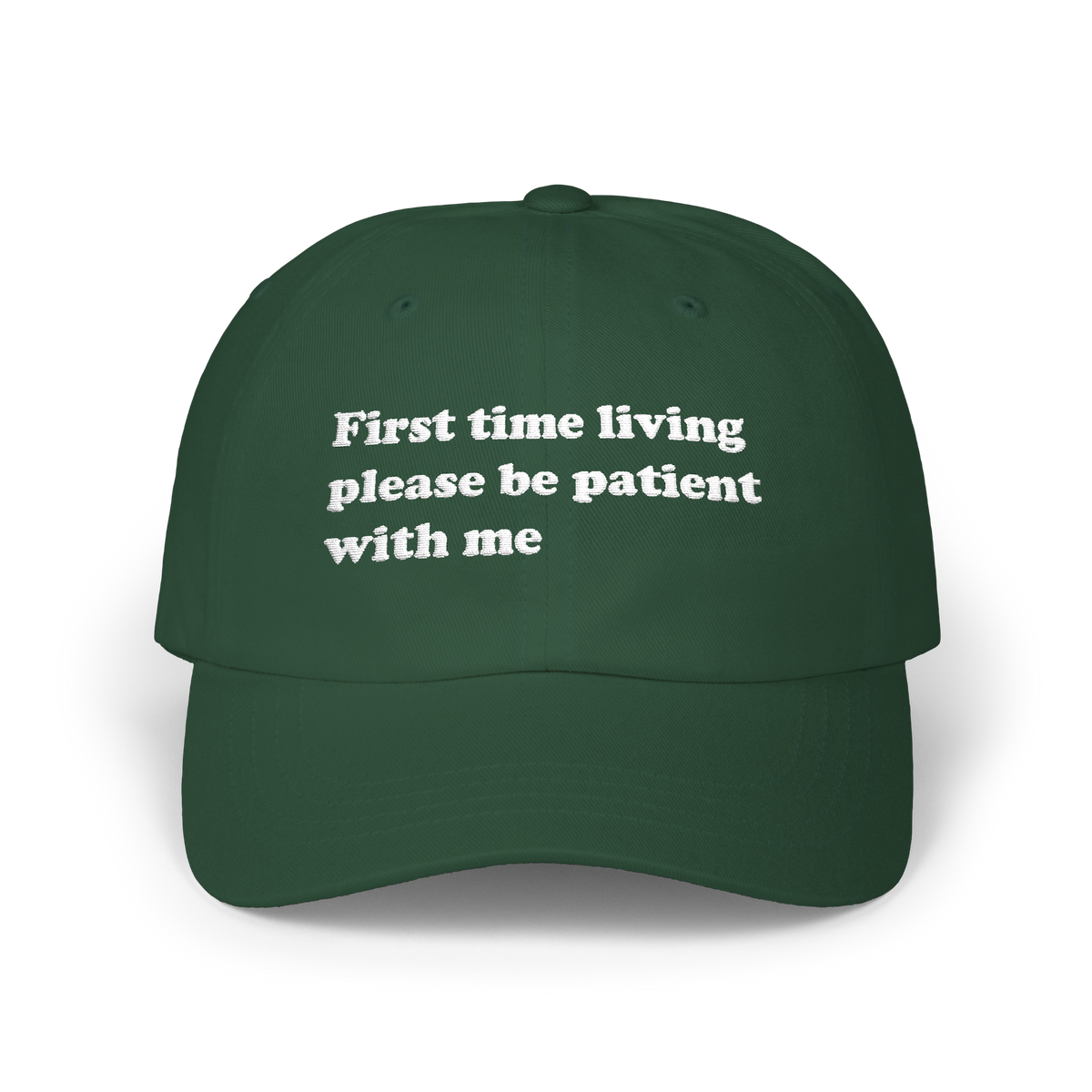 Spruce green dad hat with "First time living please be patient with me" embroidered in white on the front panel