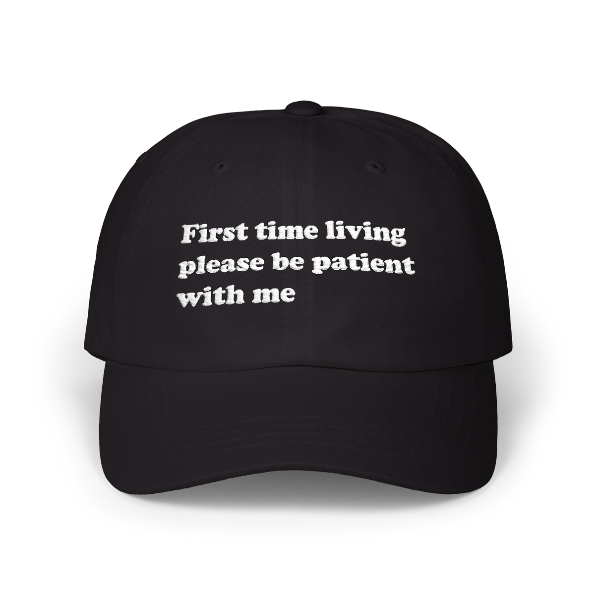 Black dad hat with "First time living please be patient with me" embroidered in white on the front panel