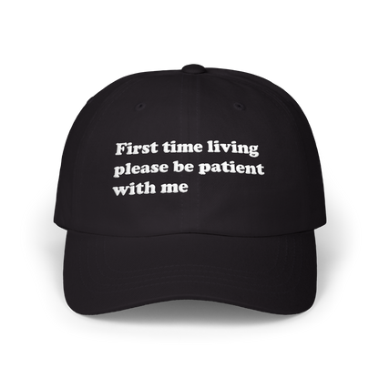 Black dad hat with "First time living please be patient with me" embroidered in white on the front panel