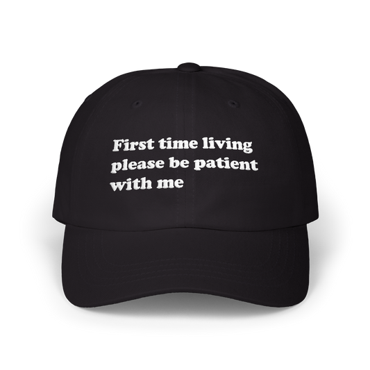 Black dad hat with "First time living please be patient with me" embroidered in white on the front panel