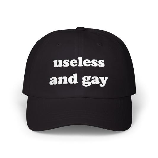 Black dad hat with "useless and gay" embroidered in white on the front panel