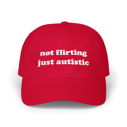 Cranberry dad hat with "not flirting just autistic" embroidered in white on the front panel