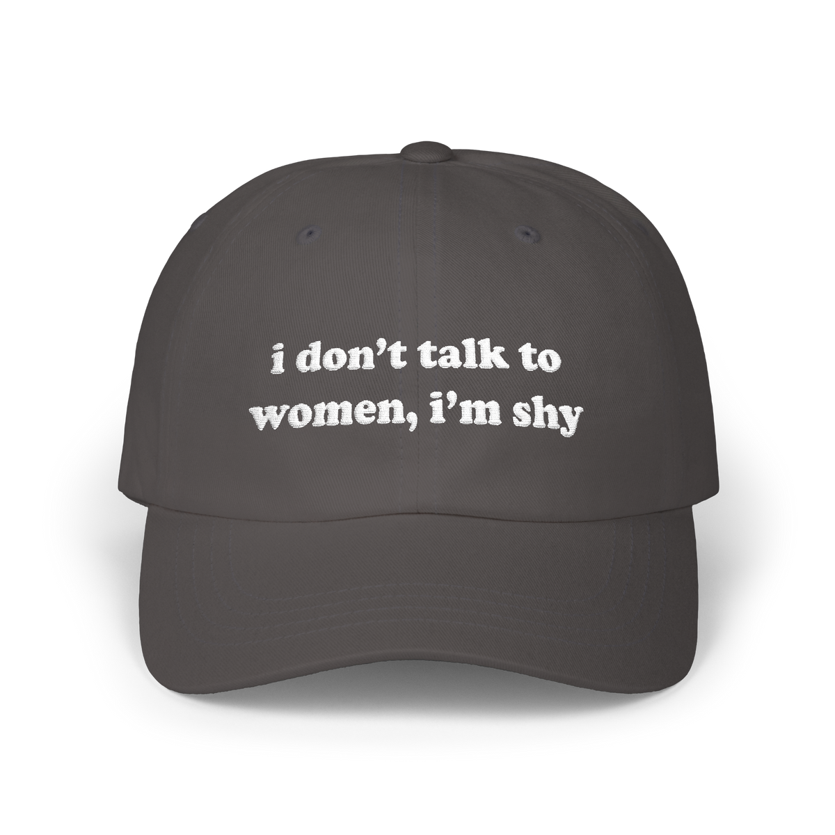 Dark grey dad hat with "i don't talk to women, i'm shy" embroidered in white on the front panel