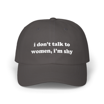 Dark grey dad hat with "i don't talk to women, i'm shy" embroidered in white on the front panel