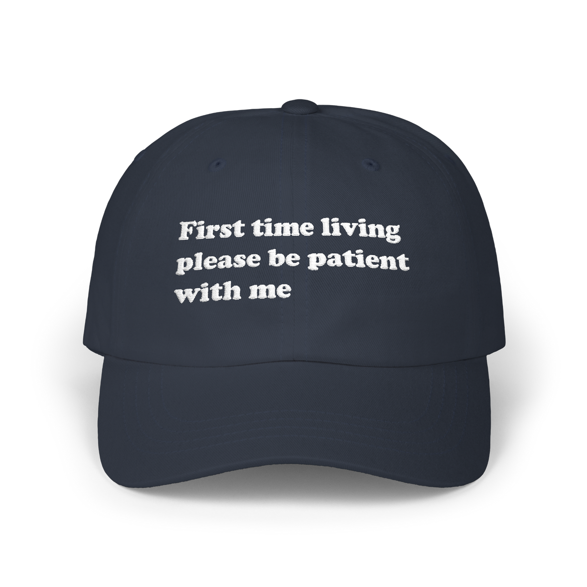 Navy dad hat with "First time living please be patient with me" embroidered in white on the front panel