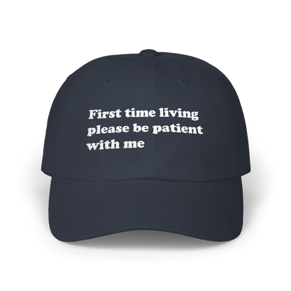 Navy dad hat with "First time living please be patient with me" embroidered in white on the front panel