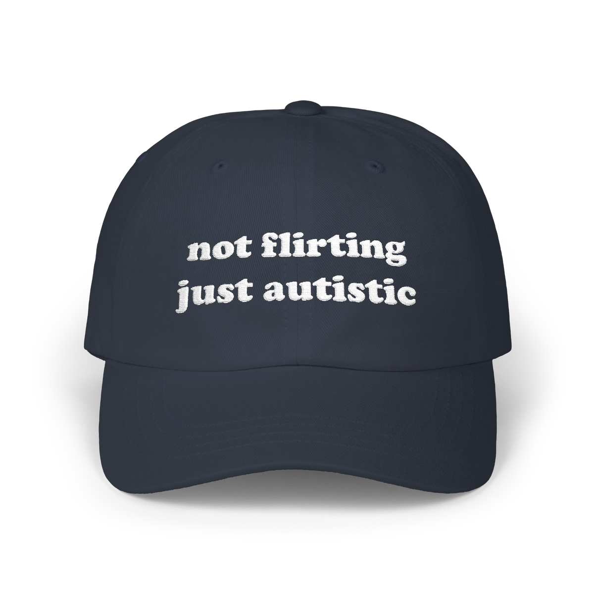 Navy dad hat with "not flirting just autistic" embroidered in white on the front panel